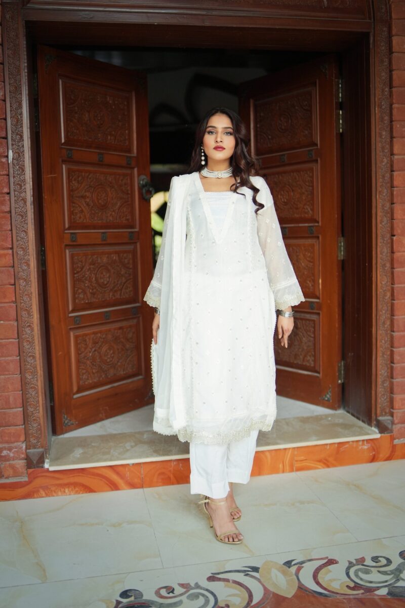White embroidered semi formal dress for women with chiffon dupatta and silk trousers, elegant Pakistani festive wear