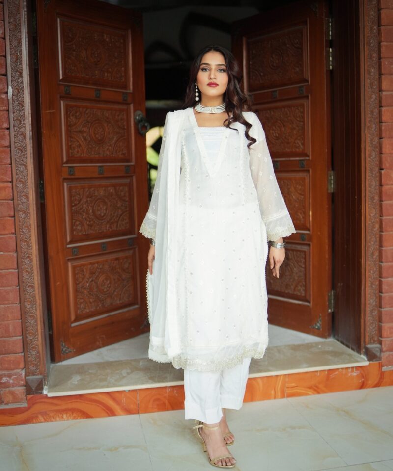 White embroidered semi formal dress for women with chiffon dupatta and silk trousers, elegant Pakistani festive wear